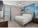 Bright bedroom with a ceiling fan, artwork, and natural light shining through the window at 7713 Graben St, Kissimmee, FL 34747