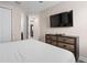 Well-lit bedroom with dresser and easy access to the hallway and other rooms at 7713 Graben St, Kissimmee, FL 34747