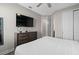 Calming bedroom with adjacent bathroom, dresser, television and closet at 7713 Graben St, Kissimmee, FL 34747