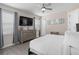 Well-lit bedroom includes a large dresser, tv, and easy access to other rooms at 7713 Graben St, Kissimmee, FL 34747