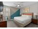 Bright, modern bedroom with geometric accent wall and comfortable furnishings at 7713 Graben St, Kissimmee, FL 34747