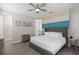 Comfortable bedroom with padded headboard, ceiling fan and adjacent bathroom at 7713 Graben St, Kissimmee, FL 34747
