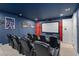Home theater room with reclining seats, large screen, and thematic decor at 7713 Graben St, Kissimmee, FL 34747