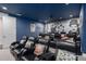 Upscale home theater with tiered seating, projector screen, and movie memorabilia at 7713 Graben St, Kissimmee, FL 34747