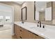 Modern bathroom with double vanity, wood cabinets, and black matte fixtures at 6000 Tarawood Dr, Orlando, FL 32819