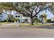 Stunning curb appeal with a large front yard and mature tree at 6000 Tarawood Dr, Orlando, FL 32819