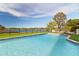 Inviting pool with lake view, surrounded by lush landscaping at 6000 Tarawood Dr, Orlando, FL 32819