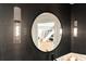 Powder room with a modern round mirror reflecting a grand staircase at 6000 Tarawood Dr, Orlando, FL 32819