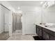 Stylish bathroom featuring a glass enclosed shower, tile flooring, and a double vanity at 1065 Splash Shot Pl # 1801, Davenport, FL 33896