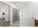 Bright bathroom featuring a glass enclosed shower, neutral color palette, and access to the bedroom at 1065 Splash Shot Pl # 1801, Davenport, FL 33896