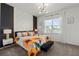 Charming bedroom with a sunflower-themed bedspread and a modern accent wall for a pop of style at 1065 Splash Shot Pl # 1801, Davenport, FL 33896