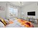 Well-lit bedroom with a view, accented by a comfortable bed with a cheerful sunflower-themed comforter at 1065 Splash Shot Pl # 1801, Davenport, FL 33896
