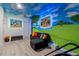 Creative bonus room with custom murals, a sofa, and modern laminate flooring at 1065 Splash Shot Pl # 1801, Davenport, FL 33896