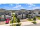 Street view of modern townhomes, showcasing stone accents and a nearby water park at 1065 Splash Shot Pl # 1801, Davenport, FL 33896