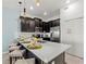 Kitchen with sleek, dark cabinets and bar seating featuring quartz countertop at 1065 Splash Shot Pl # 1801, Davenport, FL 33896
