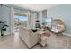 Cozy living room featuring a comfortable sofa, a stylish egg chair, and access to a balcony at 1065 Splash Shot Pl # 1801, Davenport, FL 33896