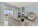 Comfortable living room with a sofa, decorative egg chair, and a balcony overlooking the neighborhood at 1065 Splash Shot Pl # 1801, Davenport, FL 33896