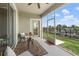 Relaxing screened patio offers serene views of the green lawn, complete with cozy outdoor seating at 1065 Splash Shot Pl # 1801, Davenport, FL 33896