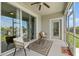 Cozy screened patio with ceiling fan, outdoor seating, and peaceful views of the lush lawn at 1065 Splash Shot Pl # 1801, Davenport, FL 33896