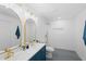 Modern bathroom with white subway tiles, a blue vanity, and gold fixtures at 36 Camellia Dr, Ormond Beach, FL 32176