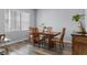 Bright dining room features a wood table with four chairs and laminate flooring at 145 Lewis Dr, Davenport, FL 33837