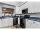 Modern kitchen with white cabinets, blue countertops, and stainless steel appliances at 145 Lewis Dr, Davenport, FL 33837