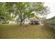 Large backyard with mature trees and a detached structure at 806 Florida Ave, Saint Cloud, FL 34769