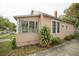 Side view of a tan house with mature landscaping at 806 Florida Ave, Saint Cloud, FL 34769