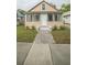 Tan house with a front porch and landscaping at 806 Florida Ave, Saint Cloud, FL 34769