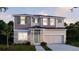 Two-story house featuring gray siding, stone accents, and a light green door at 1676 Andover Ridge Dr, Deland, FL 32720