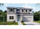 Two-story home with gray siding, neutral accents, and a two-car garage at 1676 Andover Ridge Dr, Deland, FL 32720