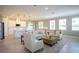 Open living area with neutral decor, comfortable seating, and kitchen views at 1676 Andover Ridge Dr, Deland, FL 32720