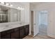 Double vanity bathroom with dark cabinets and a walk-in shower at 1677 Andover Ridge Dr, Deland, FL 32720