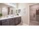Clean bathroom with double vanity, large mirror, and walk-in shower at 1677 Andover Ridge Dr, Deland, FL 32720