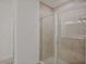 Modern bathroom with a glass shower enclosure and neutral tile at 1677 Andover Ridge Dr, Deland, FL 32720