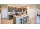 Modern kitchen with island, granite countertops, and dark brown cabinets at 1677 Andover Ridge Dr, Deland, FL 32720