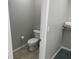 Cozy bathroom with a white toilet and a walk in closet with shelves and towels at 14501 Grove Resort Ave # 1105, Winter Garden, FL 34787