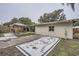 Backyard featuring a home with a concrete block wall and a grassy area with patio furniture at 1817 W Grant St, Orlando, FL 32805