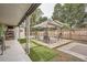 Outdoor patio area with synthetic grass, a canopy, chairs, and concrete pavers for stylish lounging at 1817 W Grant St, Orlando, FL 32805