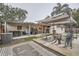Large backyard with a patio area under a canopy and synthetic grass, next to a house with outdoor storage at 1817 W Grant St, Orlando, FL 32805