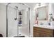 Bathroom featuring a modern vanity with an elegant sink and a corner shower with glass doors at 1817 W Grant St, Orlando, FL 32805