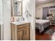 Modern bathroom featuring wood-style vanity, white countertop, and view into a bedroom at 1817 W Grant St, Orlando, FL 32805