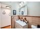 Bathroom with a decorative tile counter vanity, a mirrored medicine cabinet, and vintage tile walls at 1817 W Grant St, Orlando, FL 32805
