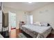Comfortable bedroom featuring hardwood floors, soft lighting, and an en-suite bathroom for convenience at 1817 W Grant St, Orlando, FL 32805