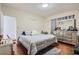 Inviting bedroom featuring hardwood floors, soft lighting, and a dresser for storage at 1817 W Grant St, Orlando, FL 32805