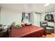 Bedroom featuring a window, ceiling skylight, and a comfortable chair for relaxing at 1817 W Grant St, Orlando, FL 32805