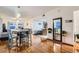 Elegant dining room with hardwood floors, modern light fixtures, and a view of the living space at 1817 W Grant St, Orlando, FL 32805