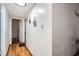 Hallway with wood floors, decorative mirrors on the wall, and doorways leading to other rooms at 1817 W Grant St, Orlando, FL 32805