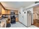 Functional kitchen with oak cabinets, tile floors, and modern appliances perfect for everyday cooking and entertaining at 1817 W Grant St, Orlando, FL 32805
