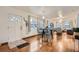Open-concept living room showcasing hardwood floors, dining area, and natural light from the front door at 1817 W Grant St, Orlando, FL 32805
